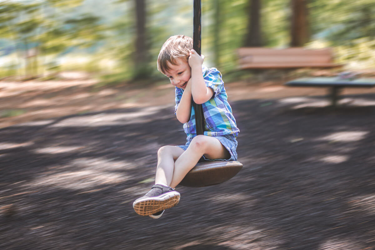 Child swinging on a rope swing